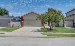 Single-story home with a well-maintained exterior, featuring a driveway, landscaped front yard, and neighboring homes in a residential community.